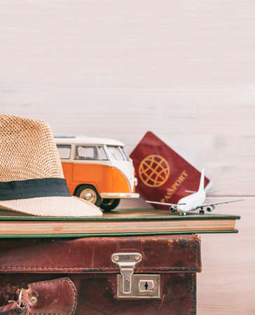 Travel packing concept, vintage suitcase, camera, map and passport on white wood background. Copy space, card templateの写真素材