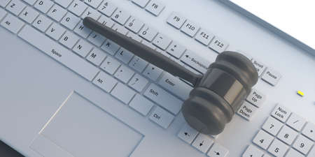 Online auction concept. Judge gavel against computer white keyboard. Law mallet on laptop keypad....