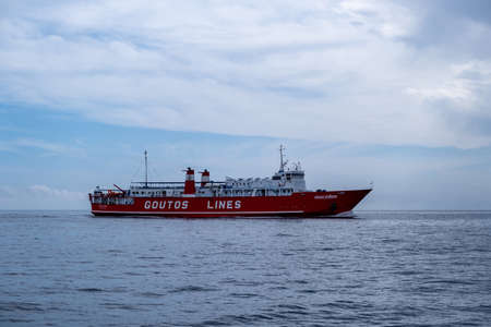 Kythnos island, Cyclades, Greece. May 15, 2021. Goutos lines Macedon ferryboat with destination Greek islands. Blue Aegean sea background for summer vacation cruise tourism.のeditorial素材