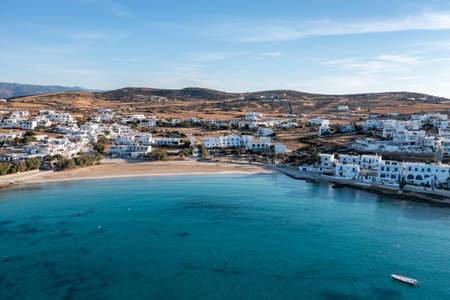 Greece, Koufonisi island, small Cyclades. Aerial drone view. Pano Koufonisi white traditional village buildings, Megali Ammos sandy beach. Calm turquise sea water, clear blue sky background.の写真素材