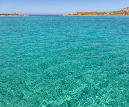 Cyclades islands, Rinia bay clear transparent water, Greece. Turquoise blue sea, island coast and...