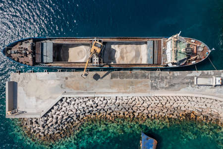 Marine works construction equipment and machinery, aerial drone top down view, Sand loading machine on a ship at Korissia port, Kea Tzia island, Cyclades, Greeceの写真素材
