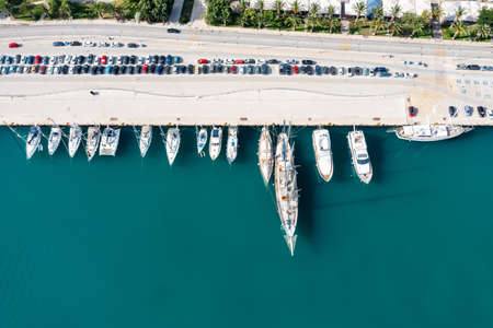 Port marina top down. Nafplio city, Greece, Aerial drone view. Sailboats and yachts moored at harbor dock, calm blue sea background. Sailing Aegean sea, summer holidays destinationの写真素材