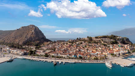 Nafplio or Nauplion city, Greece, Aerial drone view. Peloponnese old town cityscape, Palamidi castle uphill, yachts and boats moored at the dock. Blue sky with clouds background.の写真素材