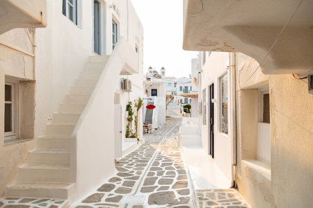 Paros island, Greece. Whitewashed buildings, narrow cobblestone alley and stairs. Naousa village traditional architecture, fresh painted white buildings. Summer vacations destination, Cycladesの素材 [FY310171107633]