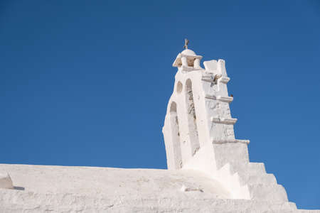 Greece, Cyclades. Folegandros island, Old church upper part at Chora town. Traditional Cycladic chapel, whitewashed walls, clear blue sky backgroundの写真素材
