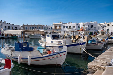 Greece, Paros island Naousa old port. May 20, 2021. Fishing boats moored at harbour dock, blue sky background. Traditional typical wooden vessels, fishing and tourists transportation, summer holidaysのeditorial素材