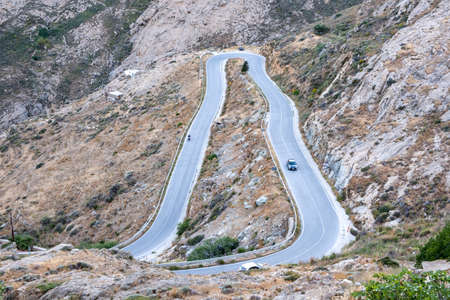 Serifos island, Cyclades Greece. High angle view of curved main road on mountains that connects two...