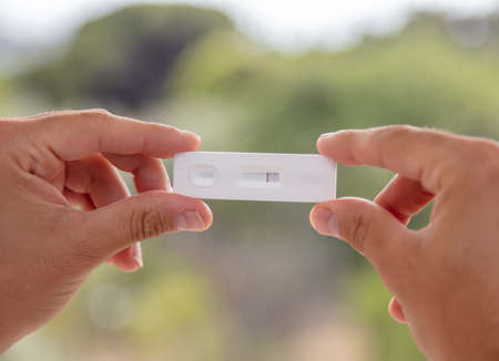 covid 19 negative result rapid test, Coronavirus self testing at home, Man hands holding kit for...