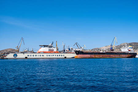 Syros island, Cyclades, Greece. May 27, 2021. Neorion shipyard harbour and industrial plant at Ermoupolis capital of Siros or Syra town. Ships, cranes, international trade, shipping, container, cargoのeditorial素材