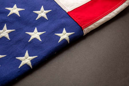 USA sign symbol. United States of America flag folded on black color background, Memorial day and 4th of July, Independence day concept. Copy space, template,の写真素材