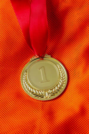 Medal gold, Winner prize award hanging with red color ribbon on athlete chest. Golden trophy in...