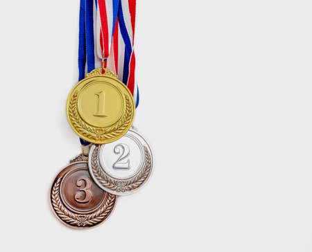 Medals set, Gold, silver and bronze. Winners, Athletes podium prize trophy concept. First, second and third place award hanging from red blue ribbon isolated on white background.の写真素材