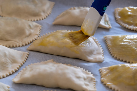 Kalitsounia traditional healthy Cretan food, Greece. Above close up view of kaltsounia uncooked pies...