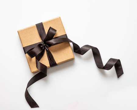 Black Friday sale concept, Gift box kraft brown paper with black ribbon bow isolated on white...