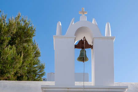 Greece, Cyclades. Folegandros island, Old church belfry at Chora town. Traditional Cycladic chapel, whitewashed walls, clear blue sky background.の写真素材