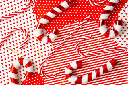 Merry Christmas. Candy canes traditional striped candies on red white festive background. Xmas pattern.の写真素材