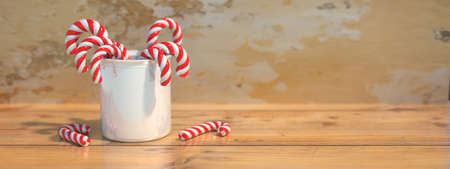 Candy canes in a ceramic pot on a wooden table, space. Merry Christmas card template. Peppermint red...