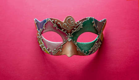 Carnival Venetian mask colorfoul handmade on red color background. Traditional festival disguise, Mardi Gras masqueradeの写真素材