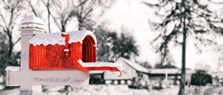 Snow covered mailbox, blur country house background. Empty retro postbox red color open with raised flag. Correspondence in winter. 3d illustrationの写真素材