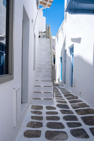 Mykonos island, Chora village. Cyclades Greece. Whitewashed buildings, narrow cobblestone alley, traditional architecture. Summer vacations destination,の写真素材