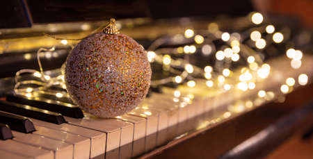 Christmas Piano music, Xmas decoration and lights bokeh background. Holiday celebration concert, party festive songs,の写真素材
