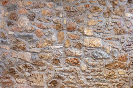 Stone wall texture background. Old stonewall traditional pattern building facade, natural material...