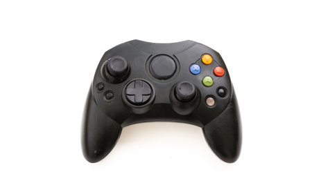 Video game controller isolated on white background. Overhead gaming console control, black color,...