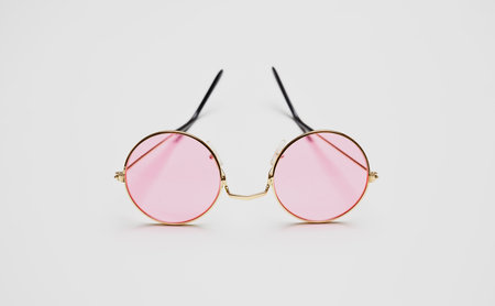 Eyeware, sunglasses with pink color lens and gold round metallic frame isolated on white background,...