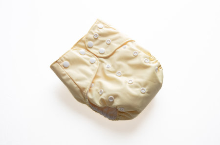 Baby diaper  isolated on white background. Reusable cloth nappy, closed, yellow color. Eco friendly, sustainable lifestyleの写真素材