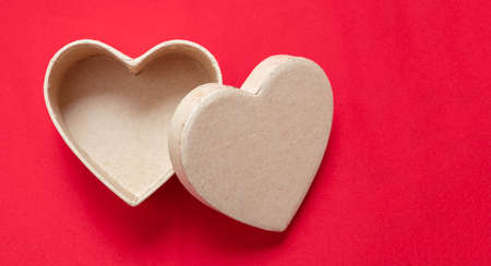 Heart shaped gift box empty open on red background. Valentine day present, love celebration, copy...