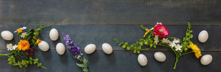 Happy Easter. Quail egg and Spring flower decoration, blue wooden table background, top view, header. Greeting card templateの写真素材