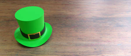 St Patricks Day leprechaun green hat isolated on wooden table background. Feast of Saint Patrick celebration, Irish traditional beer festival and party. 3d renderの写真素材