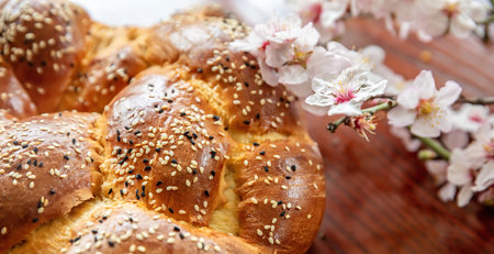 Easter sweet bread, cozonac or tsoureki on wood, close up view. Braided brioche, festive traditional...