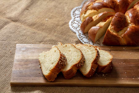Easter sweet bread, cozonac or tsoureki slice on table, Braided cut brioche, festive traditional...