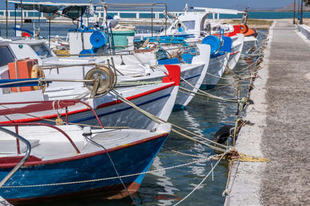 Fishing boat anchored at Elafonisos island port Greece. Wooden traditional vessel. Blue sky background. Sunny summer dayの写真素材