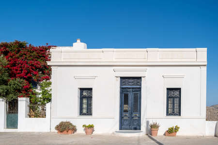 Greece, destination Cyclades. Greek Island typical architecture with whitewashed wall blue vintage...