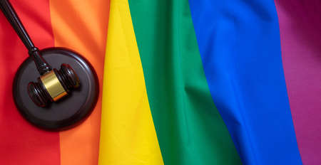LGBT Law, Gay marriage. Judge gavel on rainbow color textile, top view, Transgender rights, Copy...