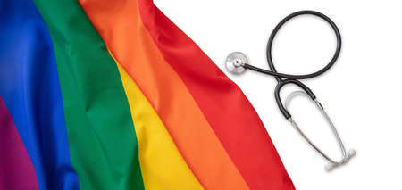 LGBT Health care. Medical Stethoscope on rainbow pride flag, white background, top view. Transgender...