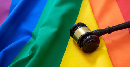 LGBT Law, Gay marriage. Judge gavel on rainbow color textile, close up view. Transgender rights, Copy spaceの写真素材