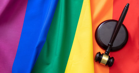 LGBT Law, Gay marriage. Judge gavel on rainbow color textile, top view, Transgender rights, Copy spaceの写真素材