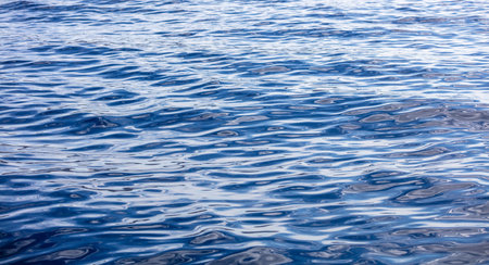 Mediterranean Sea water surface calm with small ripples. Still ocean, deep blue color background....