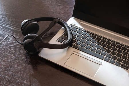 Home office, headset on a laptop, wooden table, view from above,  Call center, customer support,...