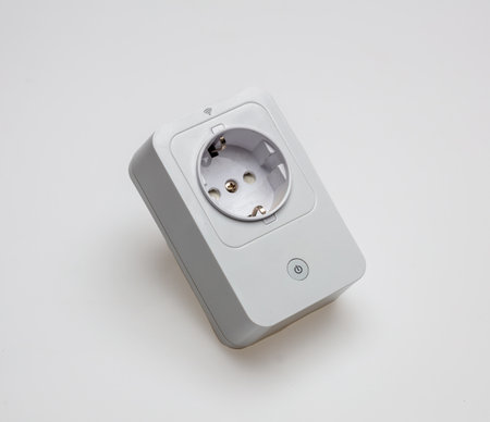 Wi Fi white socket isolated cutout on white background. Smart electric socket with on off button for wireless repeater WiFi extender on empty surface. Overhead view, copy space.の写真素材