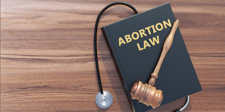 Abortion law and Health concept. Legal or illegal. Judge gavel and medical stethoscope on Abortion Law book, copy space, top view. 3D Renderの写真素材