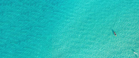 Summer vacation fun, swim and canoe kayak in infinite clear turquoise blue transparent Aegean Sea,...