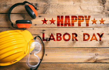 Happy Labor Day text and construction tools on wooden table, top view. United States America holiday celebrationの写真素材