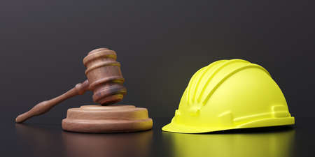 Labor, Construction lawyer. Yellow safety hardhat and judge gavel on black background, close up...