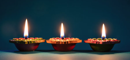Deepavali Diwali. Hindu festival of lights. Clay diyas candles. Oil lamps lit on dark background, copy space.の写真素材