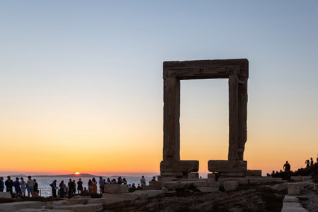 Naxos island, sunset over Temple of Apollo, Cyclades Greece. Mythology gets rest and people enjoys the sundown from the islet of Palatia.のeditorial素材